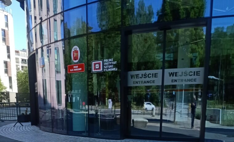 Wejście do budynku Powiśle Park z oznaczeniem Polskiego Instytutu Sztuki Filmowej. Zdjęcie z czerwca 2024 roku.